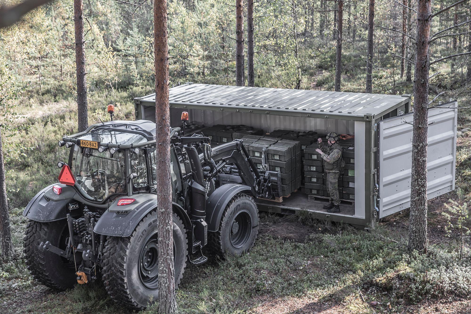 Valtra N174 tractor delivering supplies to Finnish troops in the field in containers